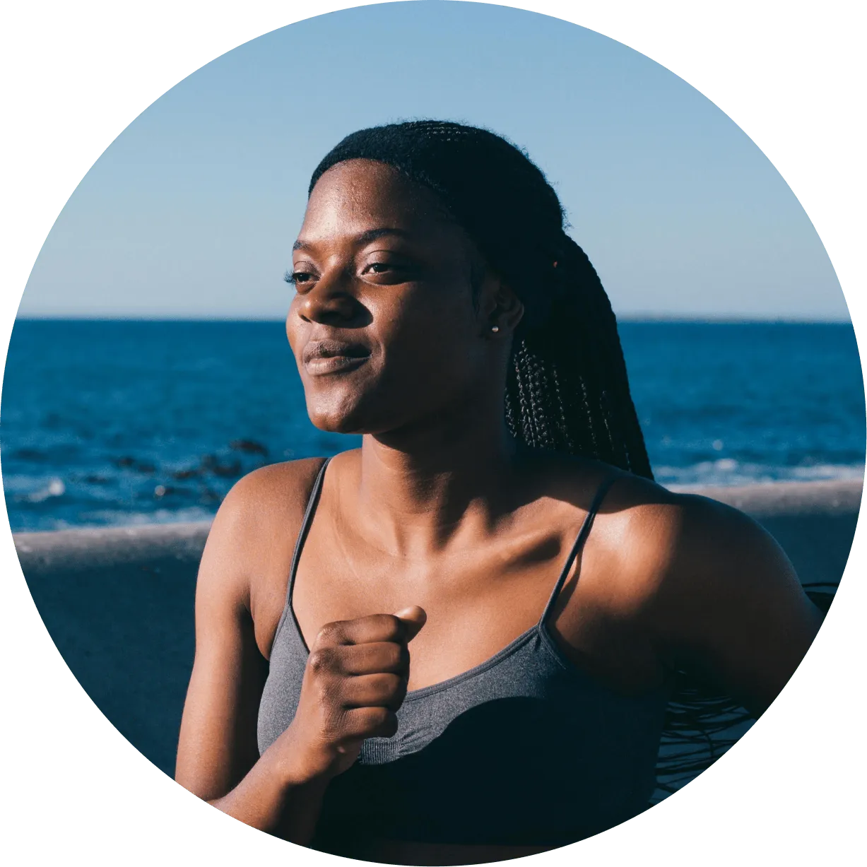 A woman standing in front of a body of water